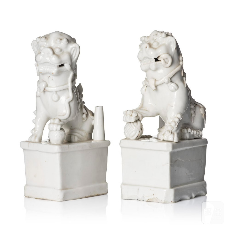 Two blanc de chine figures of buddhist lions/joss stick holders,